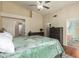 Main bedroom featuring a ceiling fan, a walk-in closet, and an en suite bathroom at 9859 W Irma Ln, Peoria, AZ 85382