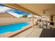 A refreshing pool and covered patio area, perfect for relaxation and entertaining outdoors at 9859 W Irma Ln, Peoria, AZ 85382