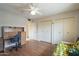 Bedroom with wood floors, ceiling fan, and a desk with office chair at 9862 N Balboa Dr, Sun City, AZ 85351