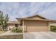 Inviting single-story home with desert landscaping, solar panels, and an attached two-car garage at 9862 N Balboa Dr, Sun City, AZ 85351