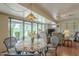 Bright living area with a view, featuring a decorative dining set and casual seating under a modern ceiling fan at 9862 N Balboa Dr, Sun City, AZ 85351