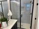 Modern bathroom featuring a glass shower with stylish patterned tile and sleek black hardware at 9965 W Flower St, Avondale, AZ 85392