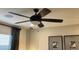 Bedroom featuring a ceiling fan, neutral walls, window with blinds, and decorative wall art at 9965 W Flower St, Avondale, AZ 85392