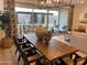 Dining area featuring a wooden table, seating for six, and sliding glass doors to the backyard at 9965 W Flower St, Avondale, AZ 85392