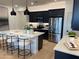 Contemporary kitchen featuring black cabinets, stainless steel appliances, and a spacious center island at 9965 W Flower St, Avondale, AZ 85392