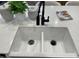 Close up of a white kitchen sink with black fixtures at 9965 W Flower St, Avondale, AZ 85392