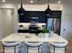 Bright kitchen featuring black cabinetry, stainless appliances, and a quartz-topped island at 9965 W Flower St, Avondale, AZ 85392