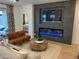 Contemporary living room featuring a fireplace, plush seating, and stylish decor at 9965 W Flower St, Avondale, AZ 85392