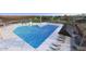 Beautiful community pool with unique design and plenty of lounge seating for residents to enjoy the sun at 9965 W Flower St, Avondale, AZ 85392