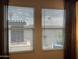 Bedroom windows with closed blinds, offering natural light and views of the outdoors at 9965 W Flower St, Avondale, AZ 85392