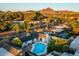 Scenic aerial view of a residential neighborhood, highlighting the home's private pool and mountain views at 1011 E Cavalier Dr, Phoenix, AZ 85014