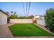 Well-maintained backyard featuring artificial turf, gravel accents, and a brick perimeter at 1011 E Cavalier Dr, Phoenix, AZ 85014