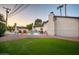 Serene backyard with a pool, lush greenery, and lounge seating, perfect for relaxation at 1011 E Cavalier Dr, Phoenix, AZ 85014