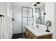 Modern bathroom featuring a glass shower, black accents, and a stylish vanity with marble countertops at 1011 E Cavalier Dr, Phoenix, AZ 85014