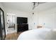 Calm bedroom featuring a ceiling fan, a TV, and an ensuite bathroom at 1011 E Cavalier Dr, Phoenix, AZ 85014