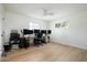 Spacious bedroom with a ceiling fan, a large window, and ample room for a home office setup at 1011 E Cavalier Dr, Phoenix, AZ 85014