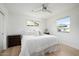 Serene bedroom with wood accent wall, ceiling fan, neutral colors and two windows providing natural light at 1011 E Cavalier Dr, Phoenix, AZ 85014