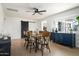 Spacious dining room featuring a modern ceiling fan, wood table, and stylish blue sideboard at 1011 E Cavalier Dr, Phoenix, AZ 85014