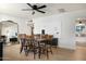 Elegant dining room featuring a modern ceiling fan, wood table, and stylish gold mirror at 1011 E Cavalier Dr, Phoenix, AZ 85014