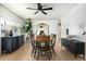 Bright dining room featuring wood floors, stylish furniture, and a large window with natural light at 1011 E Cavalier Dr, Phoenix, AZ 85014