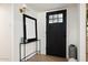 Bright entryway featuring stylish decor, a modern console table, and a sleek black front door at 1011 E Cavalier Dr, Phoenix, AZ 85014