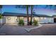 Well-maintained home featuring a covered carport, desert landscaping, and a curved walkway to the front door at 1011 E Cavalier Dr, Phoenix, AZ 85014