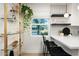 Kitchen features a bar, pendant lighting, and a window providing natural light and view to the yard at 1011 E Cavalier Dr, Phoenix, AZ 85014