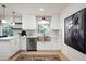 Modern kitchen featuring white cabinets, stainless steel appliances, and stylish pendant lighting at 1011 E Cavalier Dr, Phoenix, AZ 85014