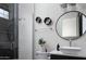 Well-lit bathroom with a glass shower, hexagonal shelving, and modern fixtures at 10242 N 57Th St, Paradise Valley, AZ 85253