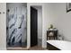 Modern bathroom with a glass-enclosed shower, stylish vanity, and sleek black and white design elements at 10242 N 57Th St, Paradise Valley, AZ 85253