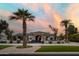 Elegant home exterior featuring a circular driveway, lush landscaping, and a grand entrance at 10242 N 57Th St, Paradise Valley, AZ 85253