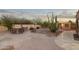 Backyard patio area with outdoor kitchen, grill, seating and desert landscaping at 10322 E Breathless Ave, Gold Canyon, AZ 85118