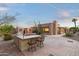 Outdoor kitchen with bar and seating area, perfect for entertaining in your private and spacious backyard at 10322 E Breathless Ave, Gold Canyon, AZ 85118