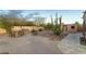 Backyard patio area with outdoor kitchen, grill, seating and desert landscaping at 10322 E Breathless Ave, Gold Canyon, AZ 85118