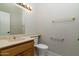 A well-lit bathroom has a wooden vanity, sink, and a neutral color scheme at 10322 E Breathless Ave, Gold Canyon, AZ 85118