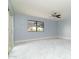 Light blue bedroom with marble floors, ceiling fan, and window offering views of the desert landscape at 10322 E Breathless Ave, Gold Canyon, AZ 85118