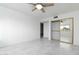 Clean, minimalist bedroom with marble floors, ceiling fan, and mirrored closet showcasing mountain views at 10322 E Breathless Ave, Gold Canyon, AZ 85118