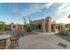 Exterior backyard view of home showcasing desert landscaping and patio at 10322 E Breathless Ave, Gold Canyon, AZ 85118