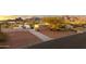 Aerial view of desert home with a long driveway, fenced yard, desert landscaping, and stunning mountain views at 10322 E Breathless Ave, Gold Canyon, AZ 85118