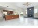 Open-concept living room featuring a stone fireplace and modern kitchen with stainless steel appliances at 10322 E Breathless Ave, Gold Canyon, AZ 85118