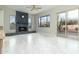 Bright living room with stone fireplace, ceiling fan, and mountain views from large windows at 10322 E Breathless Ave, Gold Canyon, AZ 85118