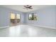 Bright living room with a ceiling fan, desert view, and sliding glass door to the patio at 10322 E Breathless Ave, Gold Canyon, AZ 85118