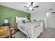 Bedroom featuring a wooden desk, ceiling fan, white furniture, and a green accent wall at 10350 W Deanne Dr, Sun City, AZ 85351