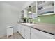 Bright kitchen featuring white cabinets, countertops, stainless steel appliances, and a modern sink at 10350 W Deanne Dr, Sun City, AZ 85351