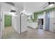 Cozy kitchen featuring white appliances, bright green accent wall and easy access to the patio at 10350 W Deanne Dr, Sun City, AZ 85351