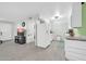 Open-concept kitchen featuring white appliances and cabinets with a view into the living space at 10350 W Deanne Dr, Sun City, AZ 85351