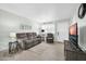 Bright living room with cozy seating, and laminate flooring, bathed in natural light at 10350 W Deanne Dr, Sun City, AZ 85351