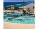 Relaxing community pool area with sun shades and lush landscaping for leisurely enjoyment at 10350 W Deanne Dr, Sun City, AZ 85351