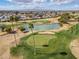 Beautiful golf course aerial view showcasing lush greens, scenic ponds and palm trees in a vibrant community at 10453 W White Mountain Rd, Sun City, AZ 85351