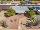 Aerial view of the property, showcasing the backyard patio, desert landscaping, and surrounding neighborhood at 10453 W White Mountain Rd, Sun City, AZ 85351